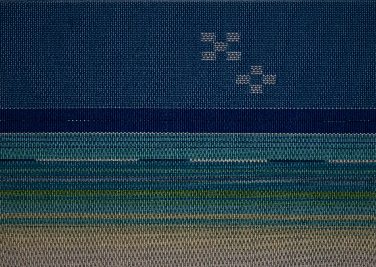 A close view of indigo-coloured Yaeyama minsa weaving