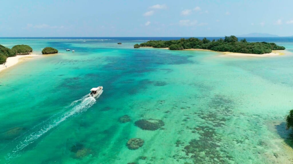 Aerial view of Ishigaki Island, Okinawa, with turquoise waters and coral reefs.