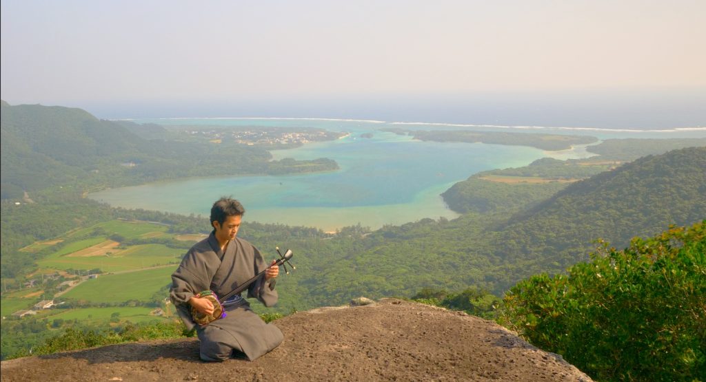 Kabira bay musician sanshin hikinh in ishigaki island japan