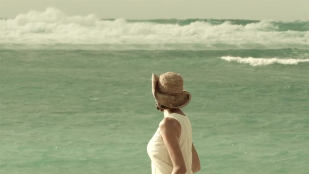 Person walking along an Ishigaki beach after a typhoon in the Yaeyama Islands