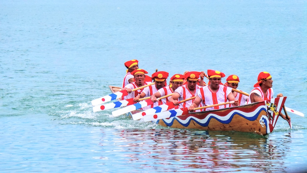 Yaeyama Haraki Dragon Boat Festival with rowers racing in decorated boats